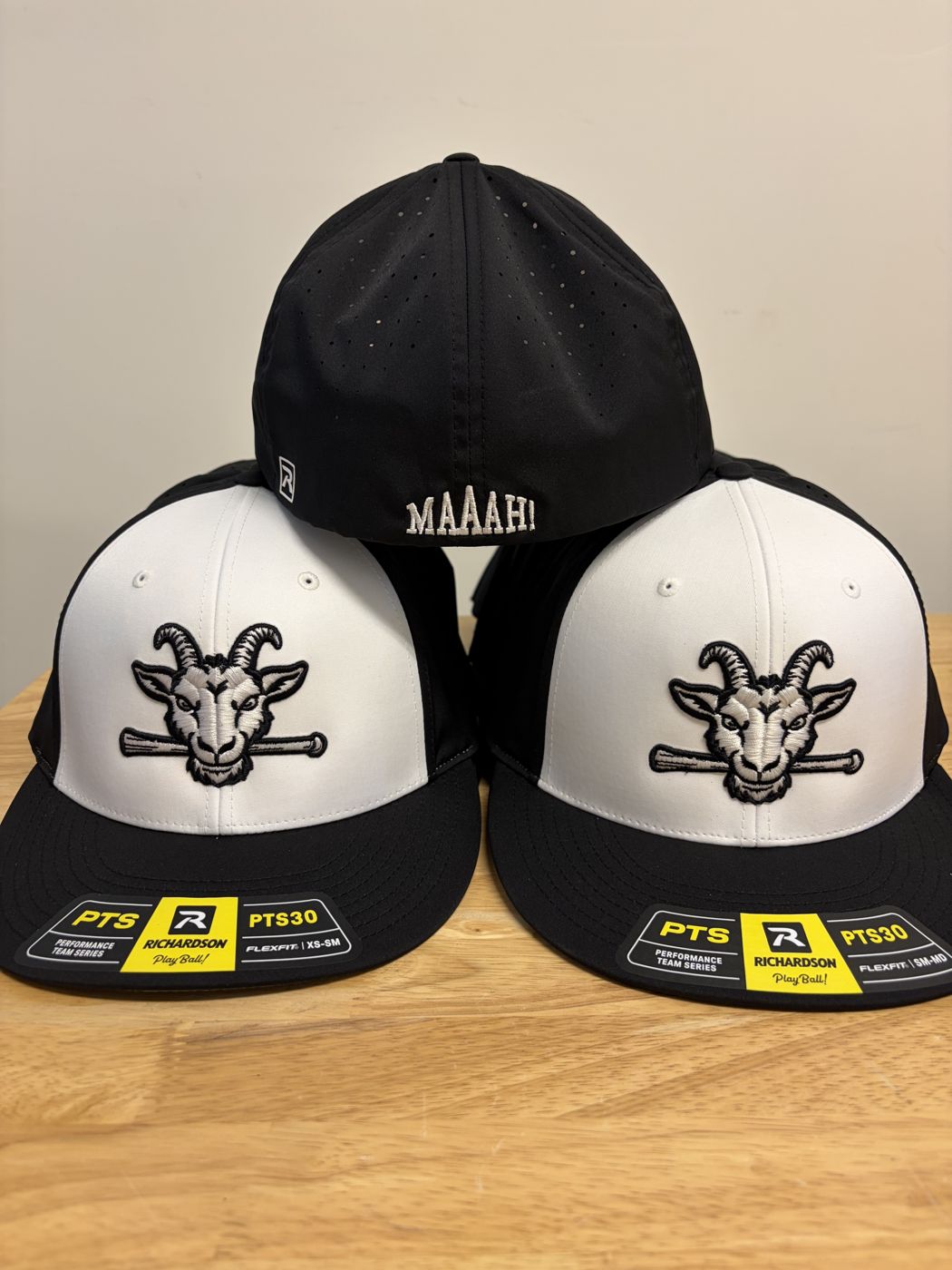 Goat logo caps with custom text stitched on the back