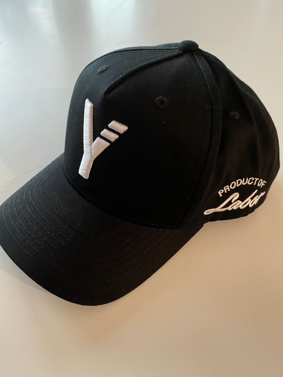 Black cap with white 3D logo on front and script on the side