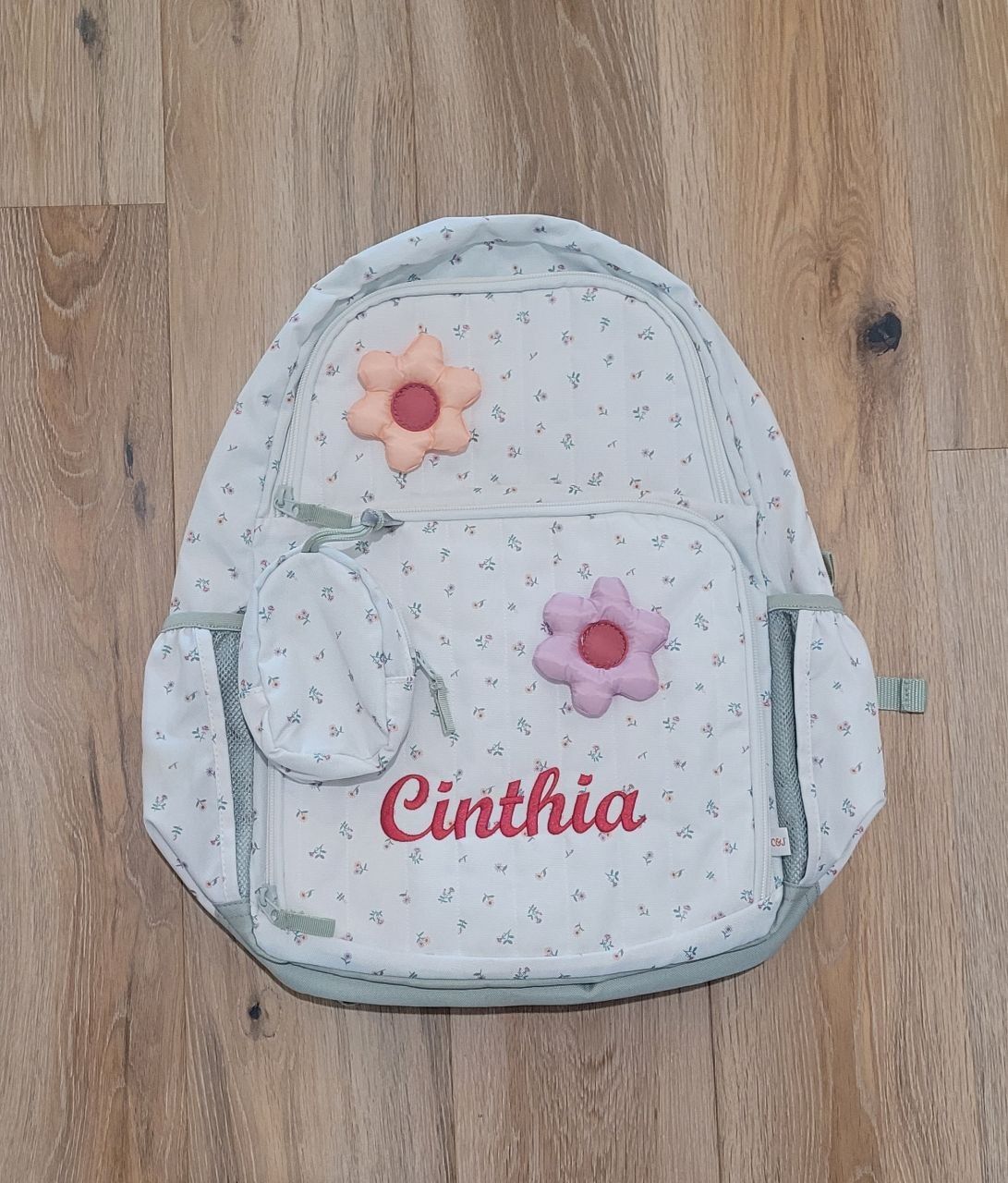 Floral backpack personalized with a name in red script