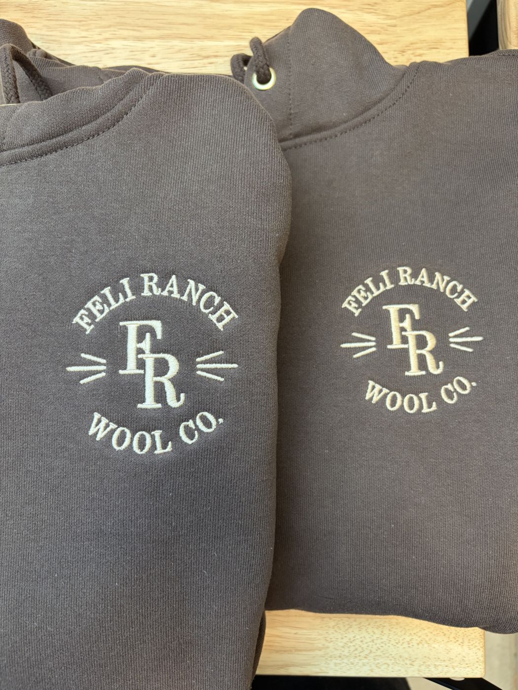 Brown hoodies with a cream circular ranch logo