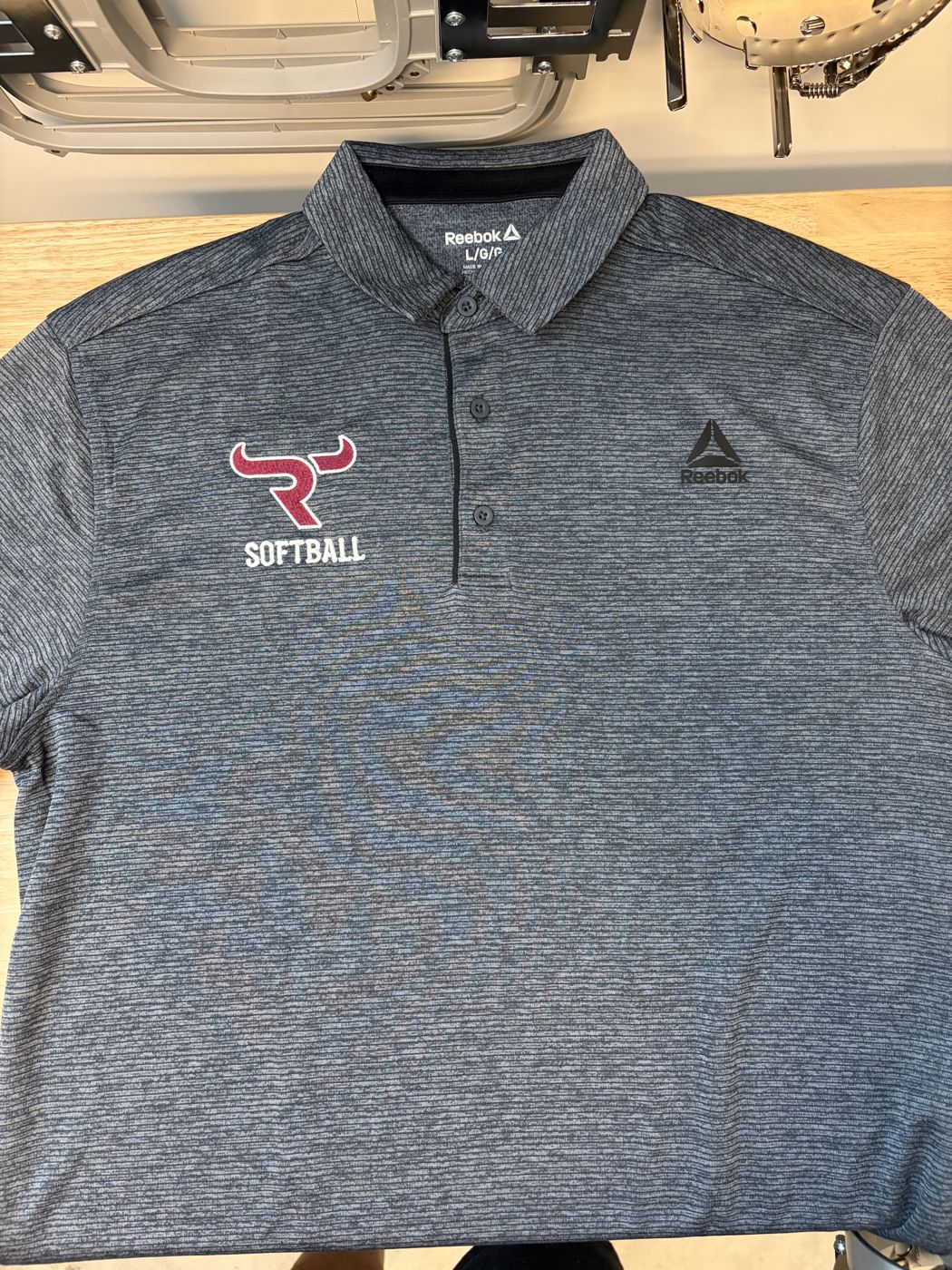 Heather gray polo with an embroidered softball logo