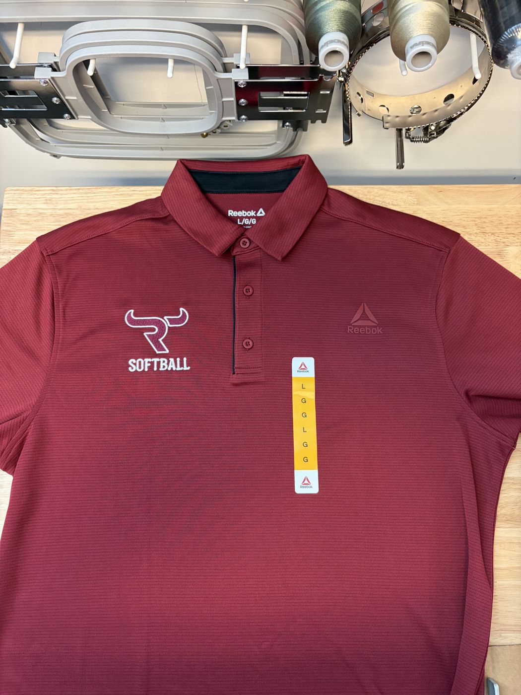 Maroon polo with an embroidered softball team logo